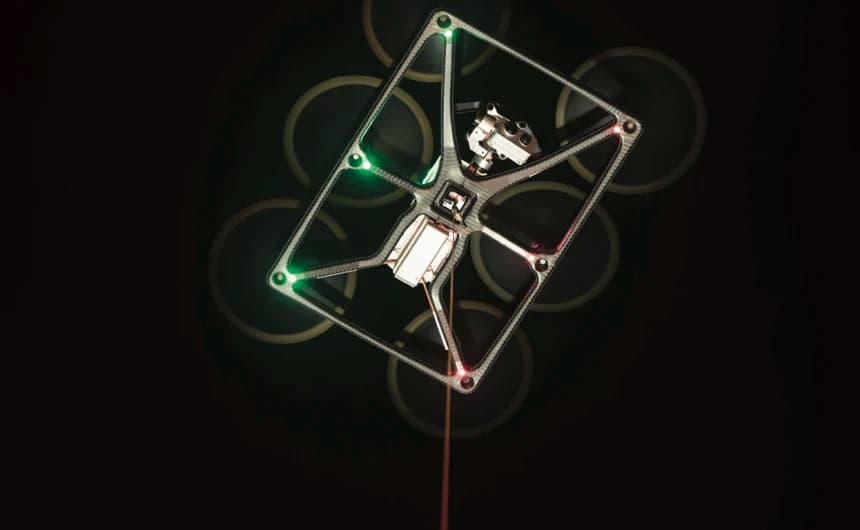 ATLAS tethered drone with green lights and camera payload in night surveillance mode